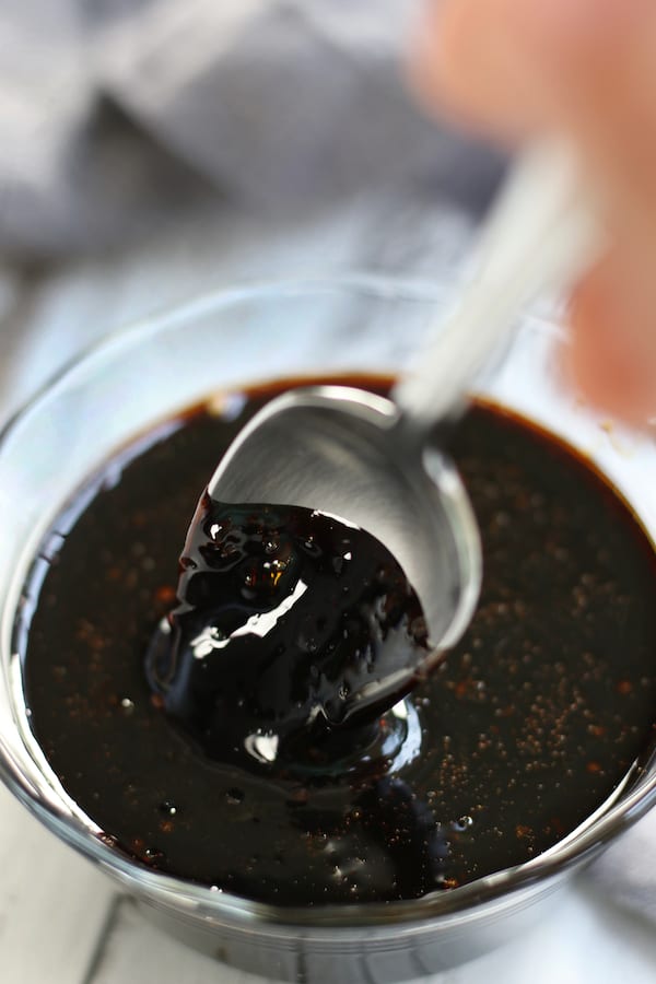 Overhead photo of a spoon being pulled from the final product of Balsamic Glaze Recipe.