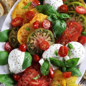 Caprese Salad with heirloom tomatoes, burrata and basil.