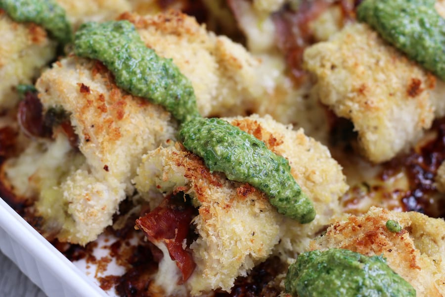 Chicken Rollatini with Panko and pesto in a white baking dish.