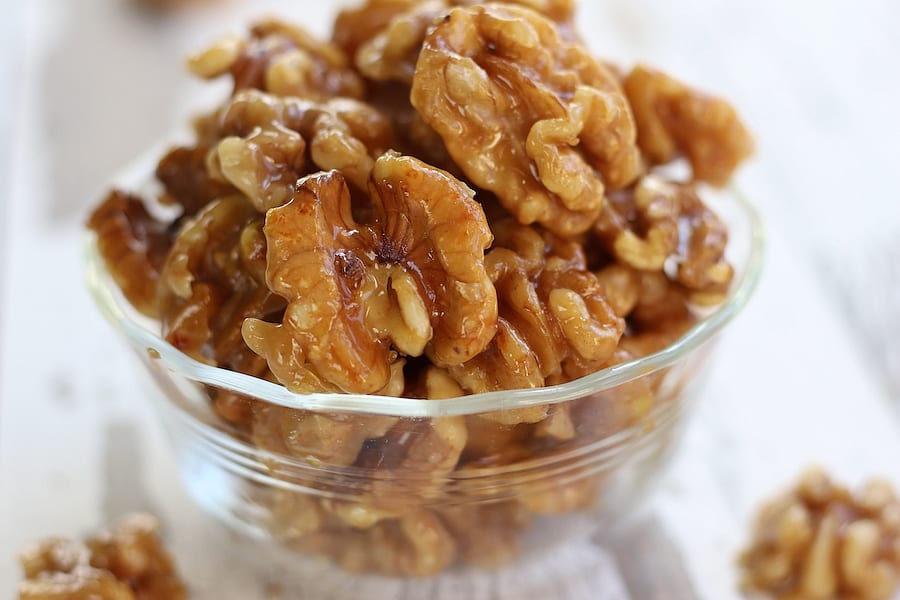 A bowl full of Glazed Walnuts.