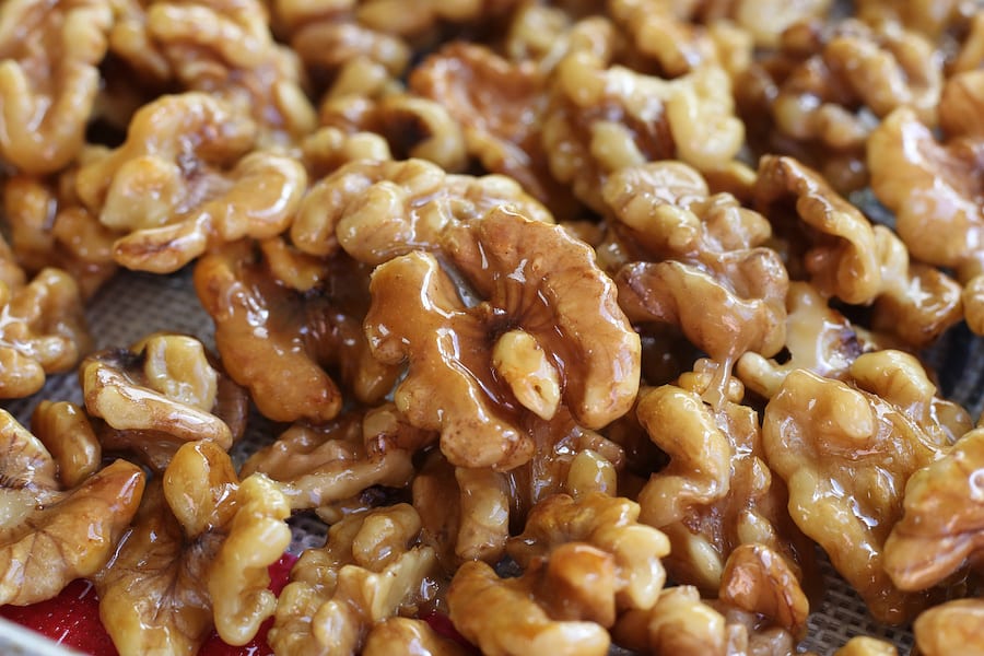 Unclose photo of Honey Glazed Walnuts spread on a cookie sheet.