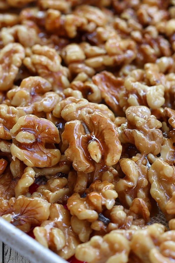 Several Honey Walnuts on a cookie sheet.