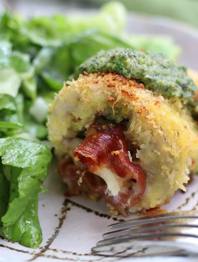 Pesto Chicken Rollatini on a plate with salad.