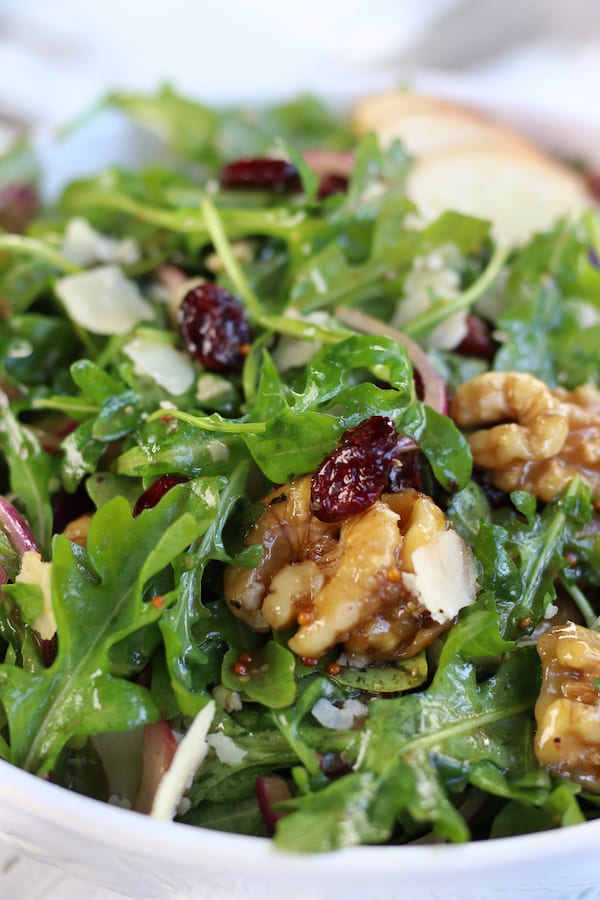 up close Rocket Salad with cranberries, pear and walnuts.