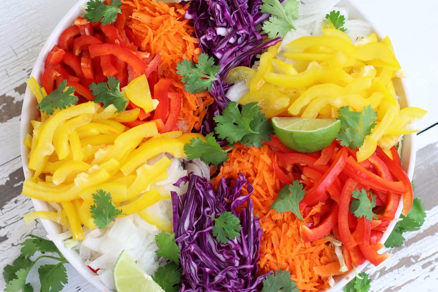 Overhead photo of shredded cabbage and chopped veggie for Vegetable Salad recipe.