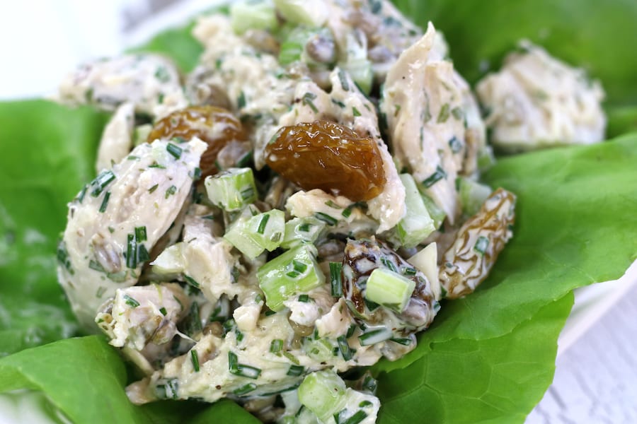 A scope of Healthy Chicken Salad on butter lettuce leaves.
