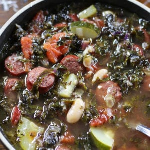 Bowl of Kale Soup with white beans and sausage.