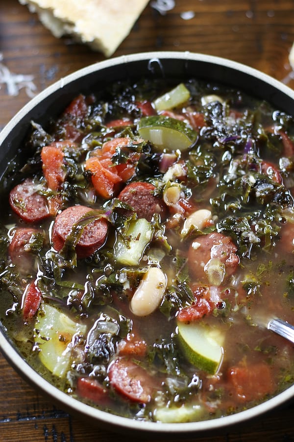 Bowl of Kale Soup with white beans and sausage.
