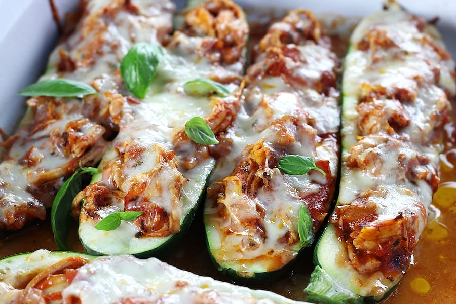 Stuffed Courgettes in a pan with shredded chicken, Pomodoro sauce and mozzarella cheese.