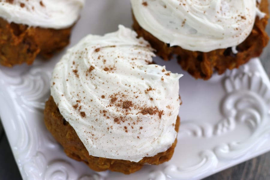 Iced Pumpkin Cookies sprinkled with ground cinnamon.