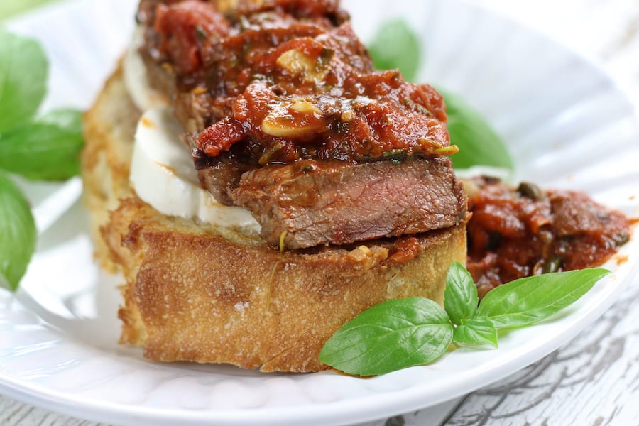 Italian Beef Sandwich with Pizzaiola sauce and slice of mozzarella.