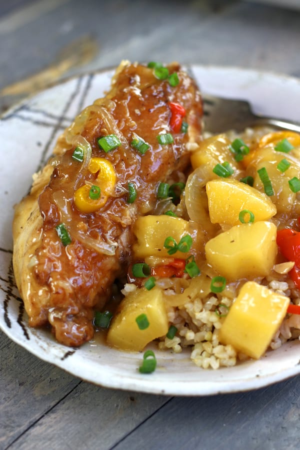 Sour and Sweet Chicken on a plate with large pineapple chunks.