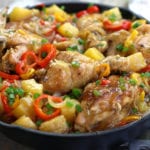 Sweet and Sour Chicken Recipe with whole chicken pieces in a cast iron skillet.