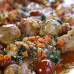 A big bowl of Contadina Chicken Stew with cherry tomatoes, mushrooms and diced carrots.