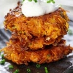 Stack of three Sweet Potato Cakes on a gray plate.