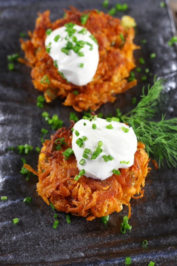 Two patties on a plate from Sweet Potato Cakes Recipe.