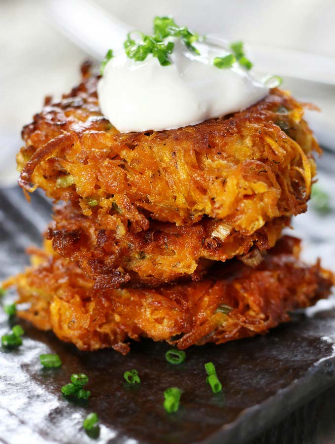 Stack of three Sweet Potato Cakes on a gray plate.