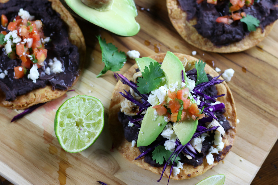 Overhead photo of Black Bean Tostadas with several different toppings.