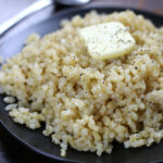 Healthy Rice Recipe that is cooked on a black plate.