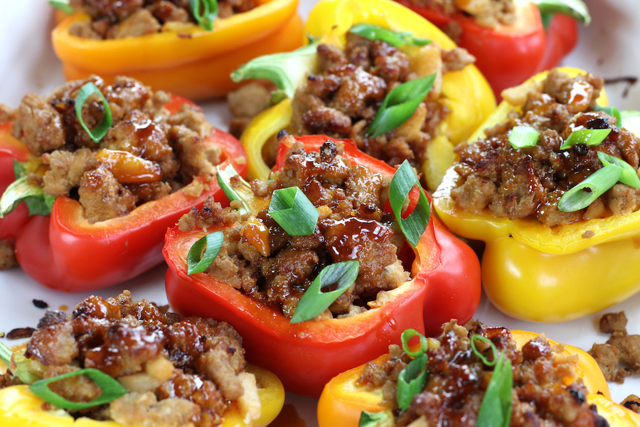 Chicken Stuffed Peppers lined up in a white roasting pan.