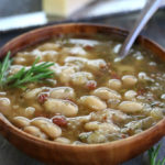 A serving of Italian White Bean Soup in a brown bowl.