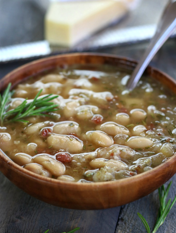 A serving of Italian White Bean Soup in a brown bowl.