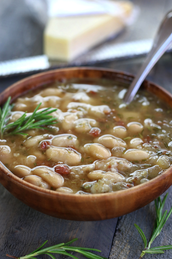 A bowl of White Bean Soup with freshly grated Parmesan on top.