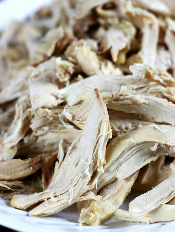 Boiled Chicken pieces on a white platter.