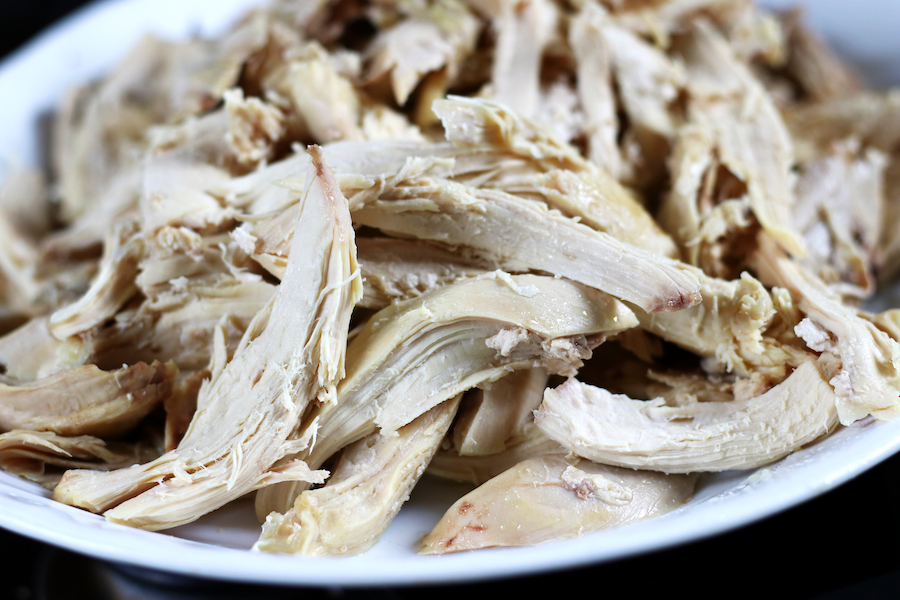 Platter full of shredded chicken from Easy Boiled Chicken recipe.