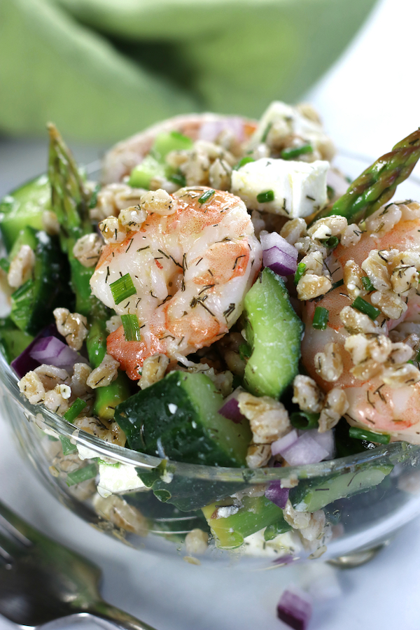 Grain Salad in a bowl sitting on a white table with a green napkin.