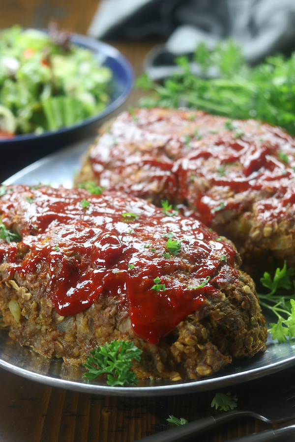 Two meatloafs on a silver platter from Mom's Classic Meatloaf recipe.