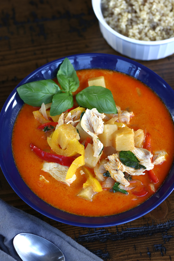 Pineapple Curry with chicken and bell peppers in a blue bowl.