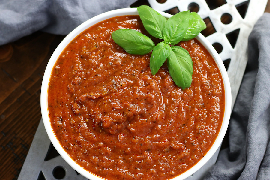 Freshly made Sauce Napolentana in a white bowl sitting on top of a trivet.