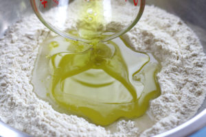 Addition of Olive Oil and Water to Flours in the making of Pici Pasta.