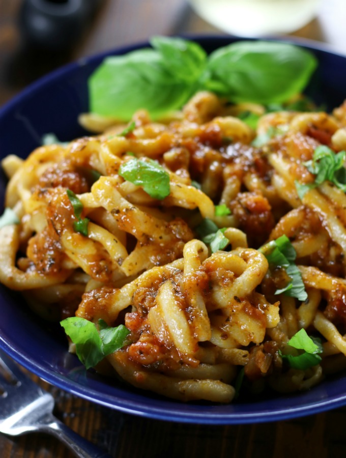 Pici All'Aglione Recipe (Tuscan Pasta with Tomato-Garlic Sauce in a blue serving bowl.