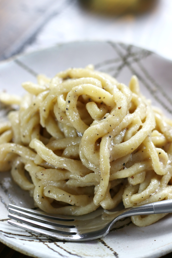 Pasta Cacio e Pepe served on a plate with a fork.