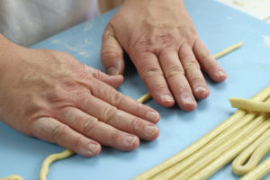 Hand Rolling of the individual Pici Noodles.