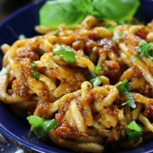 Sugo All'Aglione (Tomato garlic Sauce) covers homemade pasta.