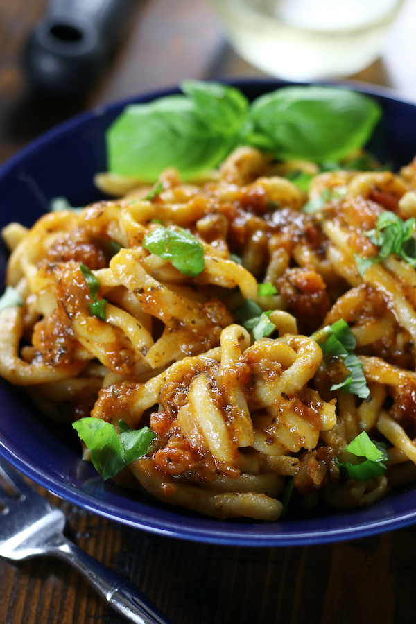 Sugo All'Aglione (Tomato garlic Sauce) covers homemade pasta.