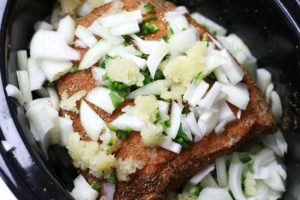 Adding of Onion, Garlic and Jalapeño to Carnitas Roast.