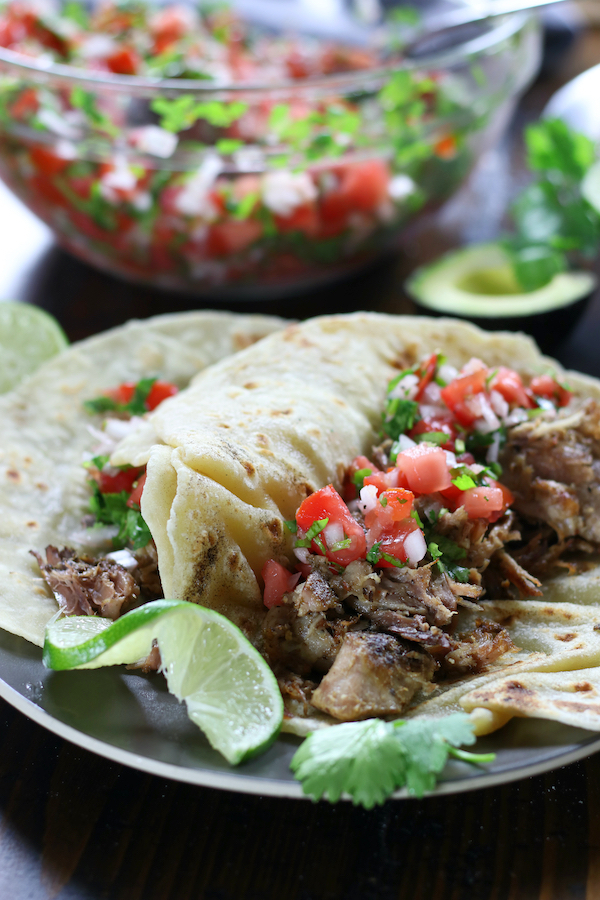 Made up plate of Carnitas Recipe with salsa and lime.