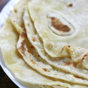 Fresh made tortillas on a white plate from Flour Tortillas Recipe.