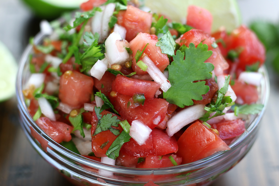 Homemade Salsa with large chunky pieces of tomato.