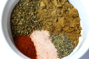 Spices for Pork Carnitas in a small white bowl before mixing.