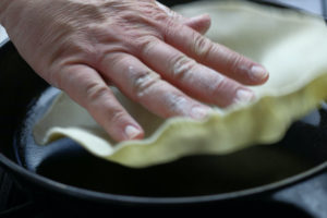 Adding Uncooked Flour Tortilla To a Heated Pan