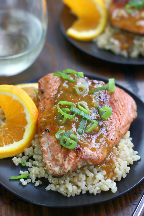 Glazed Salmon sitting on top of brown rice.