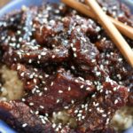 Up close photo of Crispy Sesame Beef in a blue bowl.