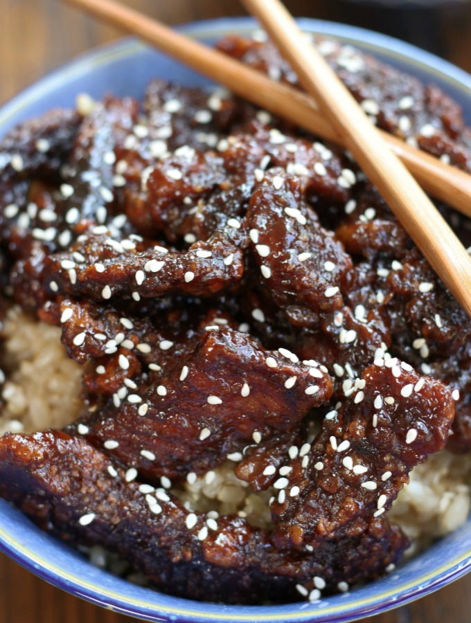 Up close photo of Crispy Sesame Beef in a blue bowl.