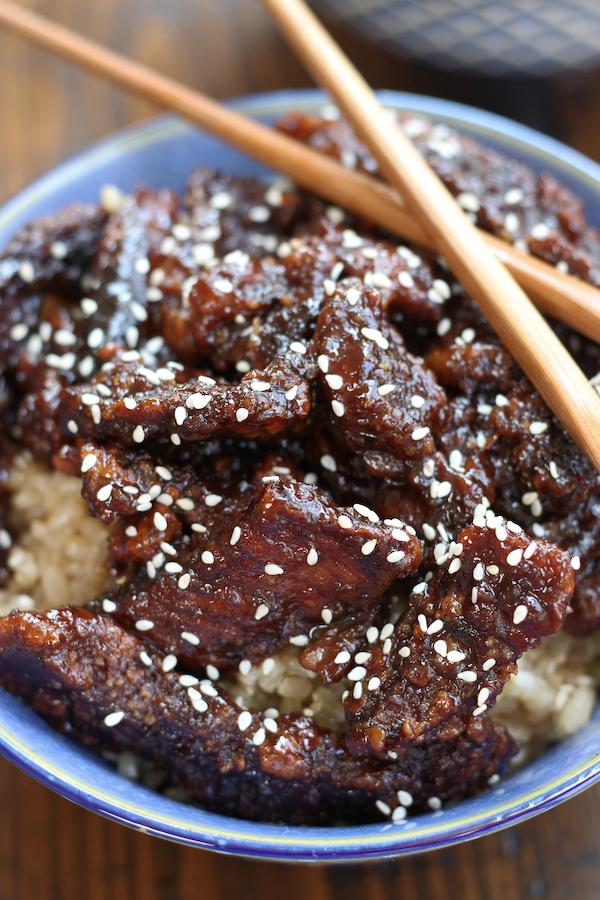 Overhead picture of Sesame Beef in a serving bow with a pair of chopsticks.