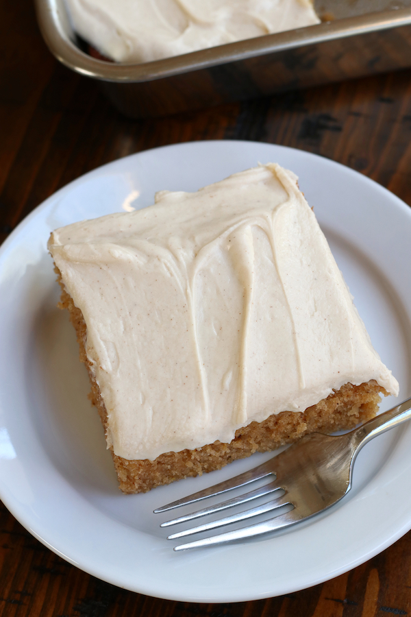 A served piece of Apple Spice Cake Recipe on a white plate with a fork.